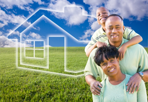 Picture of a family standing in a field.