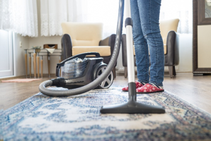 A man pulling registers off air vents.